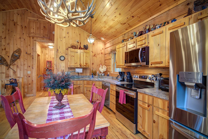 Dining area with deer antler light fixture in Log Cabin Rental Boone Blowing Rock NC 
